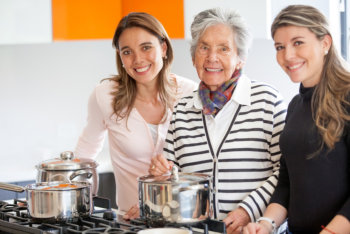 caregivers and elderly woman smiling