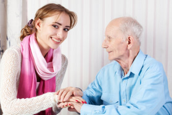 caregiver holding her patient's hands