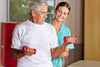 caregiver assisting his patient in exercising