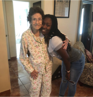 caregiver and elderly woman smiling